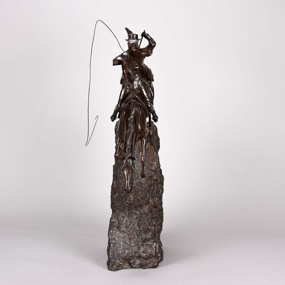 A wonderful limited edition bronze study of horseman riding his steed down a very steep and rocky drop one handed with his bull whip in the other hand with good rich deep brown patina and very Fine hand chased surface detail, signed J Knight and