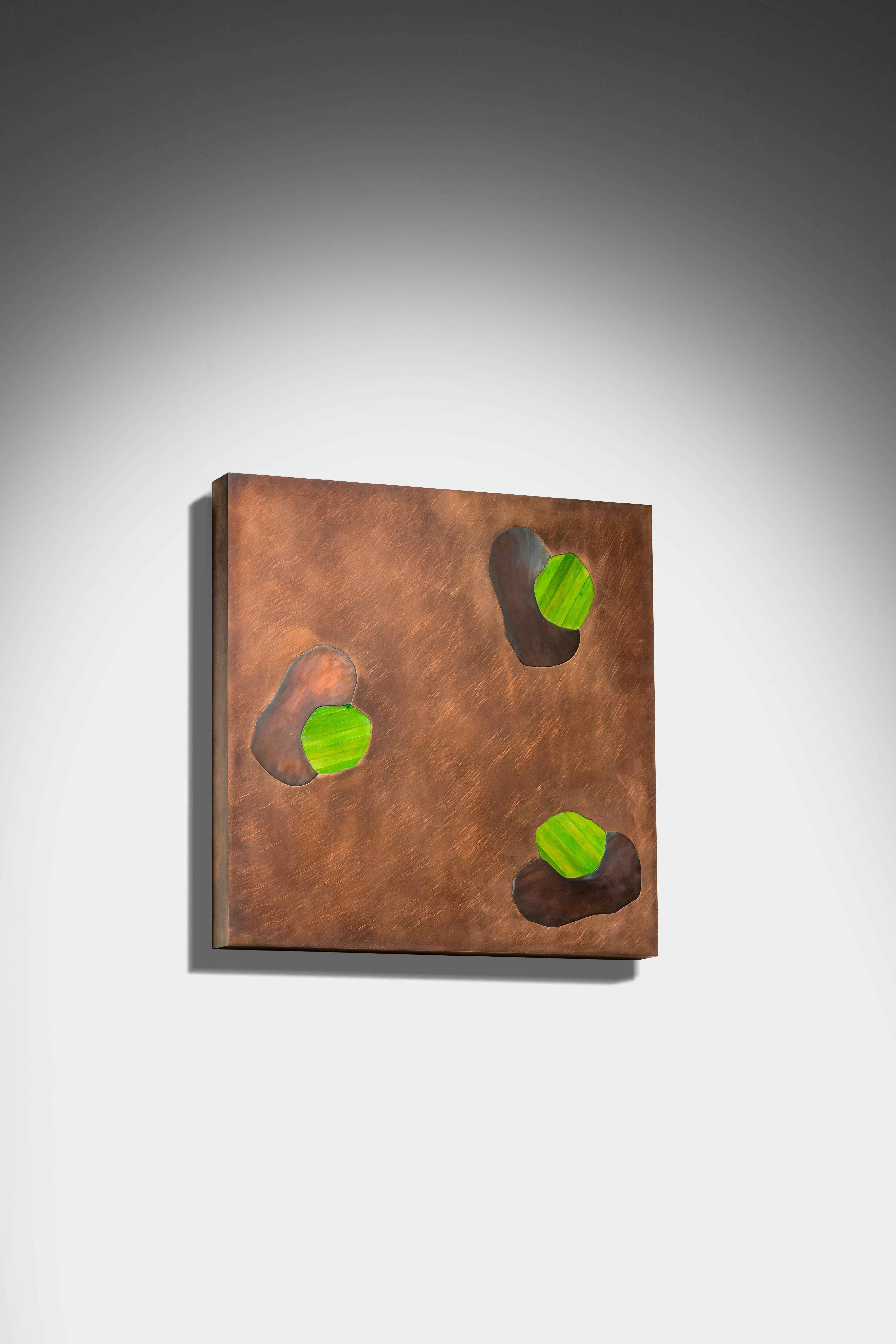Abstract forms in colours of subtle contrasts seem to be in constant movement in the backdrop of the rich brass Dreamform Wall Art I with gentle interventions of green straw marquetry. Dreamy, elegant and hard to take your eye off this delightful
