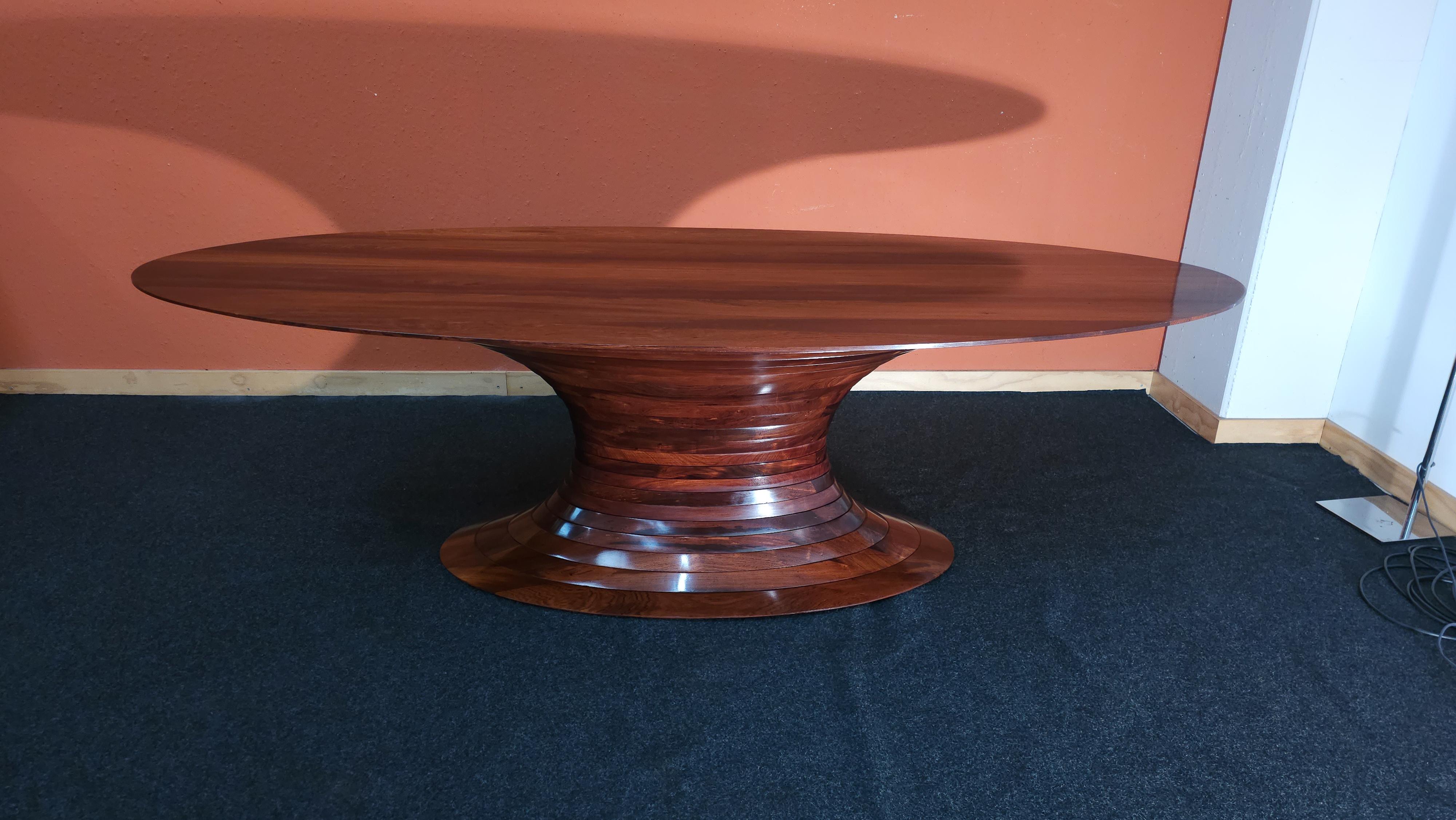This extraordinary dining table is a handmade masterpiece crafted from exquisite Indian Rosewood, featuring twenty-two captivating concentric rings. Unrivaled in its splendor, every detail has been lovingly smoothed and finished with hand-polished