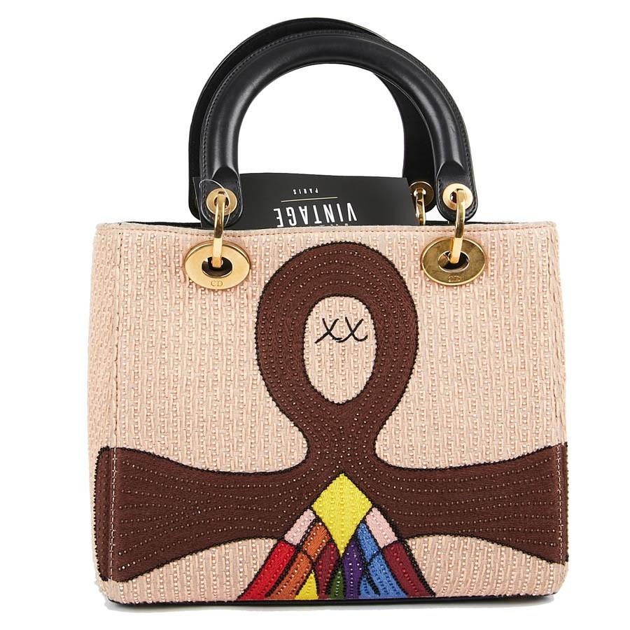 Limited Edition Lady DIOR Multicolored Judgment Bag. This bag is made of silk threads, bead embroidery, metal, black leather handle and flap. Collection Dady Dior Vert Tarot Collection 2018. Hardware in golden brass metal.
This Italian-made bag is