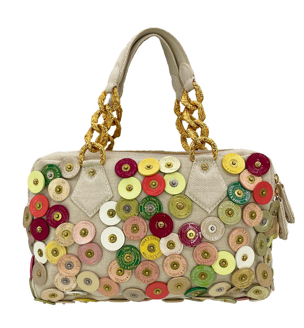 Limited Edition Louis Vuitton Polka Dots Fleur Tinkerbell Bag in excellent condition. From the spring/summer 2007 runway, limited edition multi color leather disc coins with gold accents surround exterior over a beige canvas body. Front flap pocket