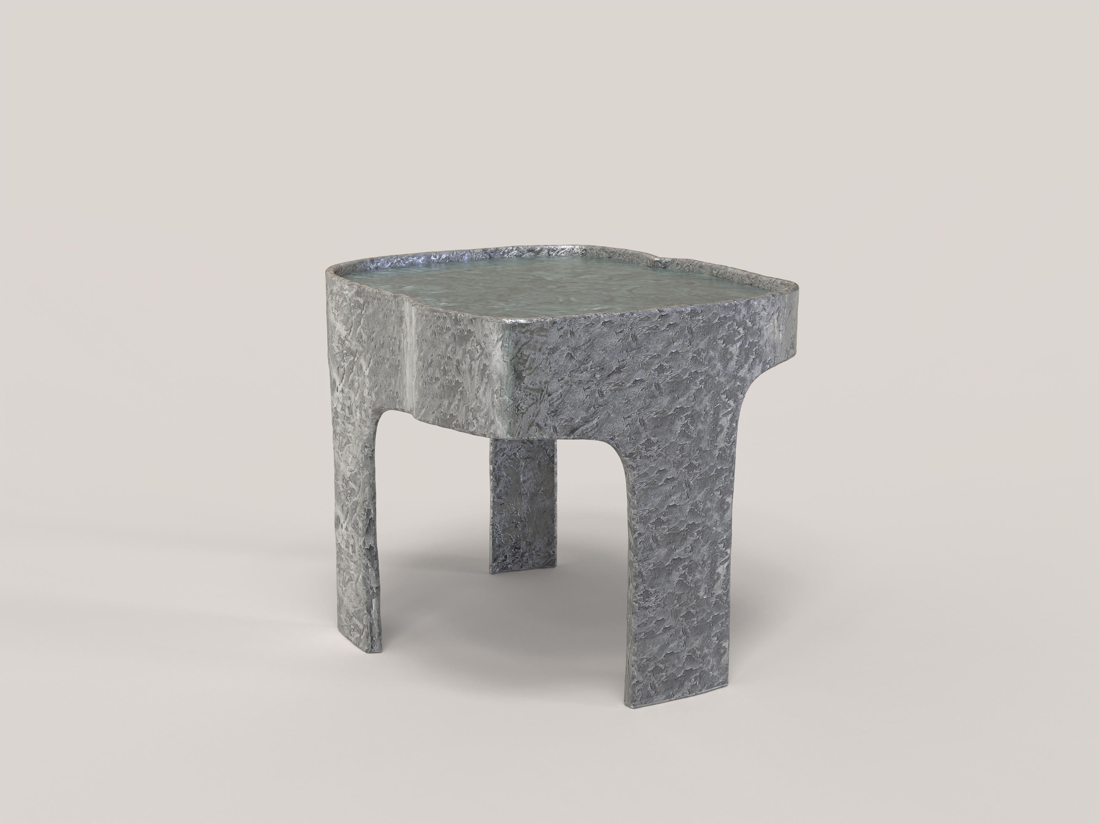Sumatra V1 is a 21st Century side table made by Italian artisans in aluminium with an extraordinary Green Guatemala marble plane. It is part of the collectible design language Sumatra that has been developed by the Edizione Limitata's art research