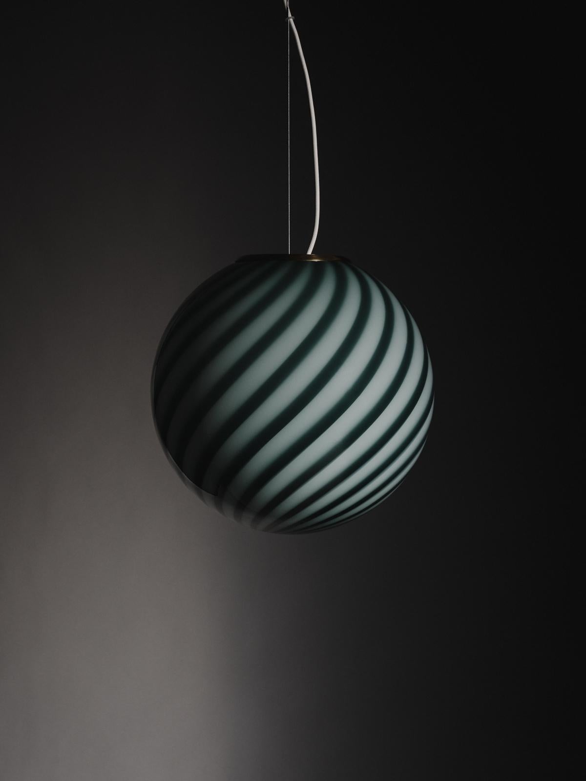 A limited edition of 50, this sculptural sphere-shaped pendant ceiling lamp is crafted from mouth-blown opaline glass in Petrolio: a deep and rich shade of green. The lamp features an original swirl pattern obtained using a 1970s mould that gives