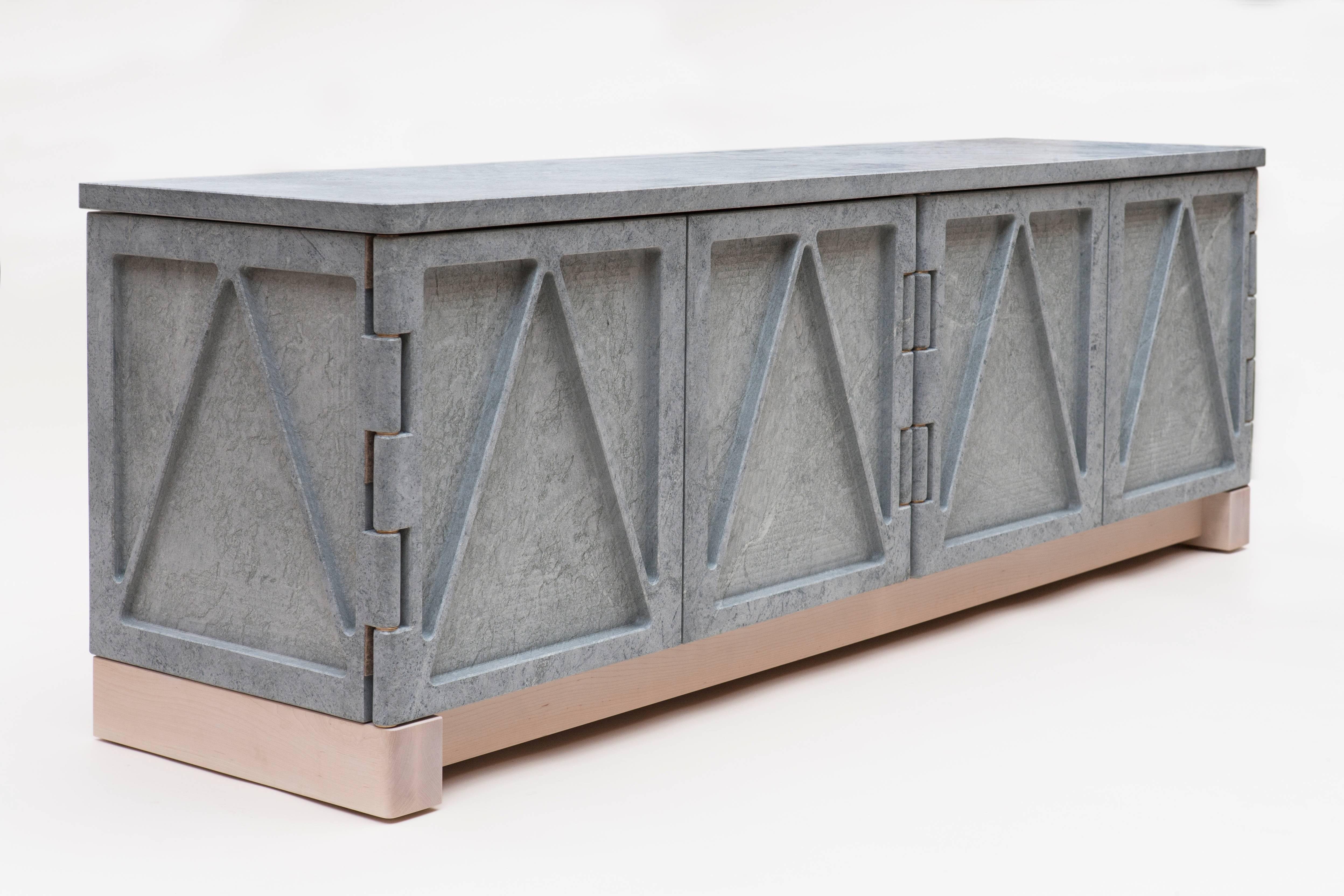 A part of the “Qualities of Material” collection, this stone credenza has a triangular relief pattern milled into the exterior panels, which removes excess weight and allows the remaining ribs to retain the material’s strength. The soapstone cabinet