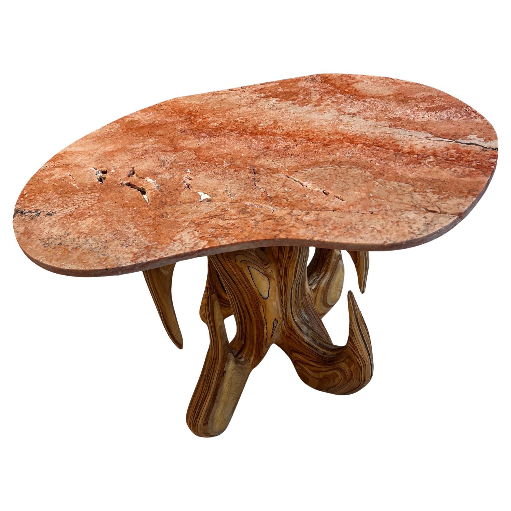 Limited edition side table with tumbled Antique Rouge marble top and sculpted base from layered maple plywood