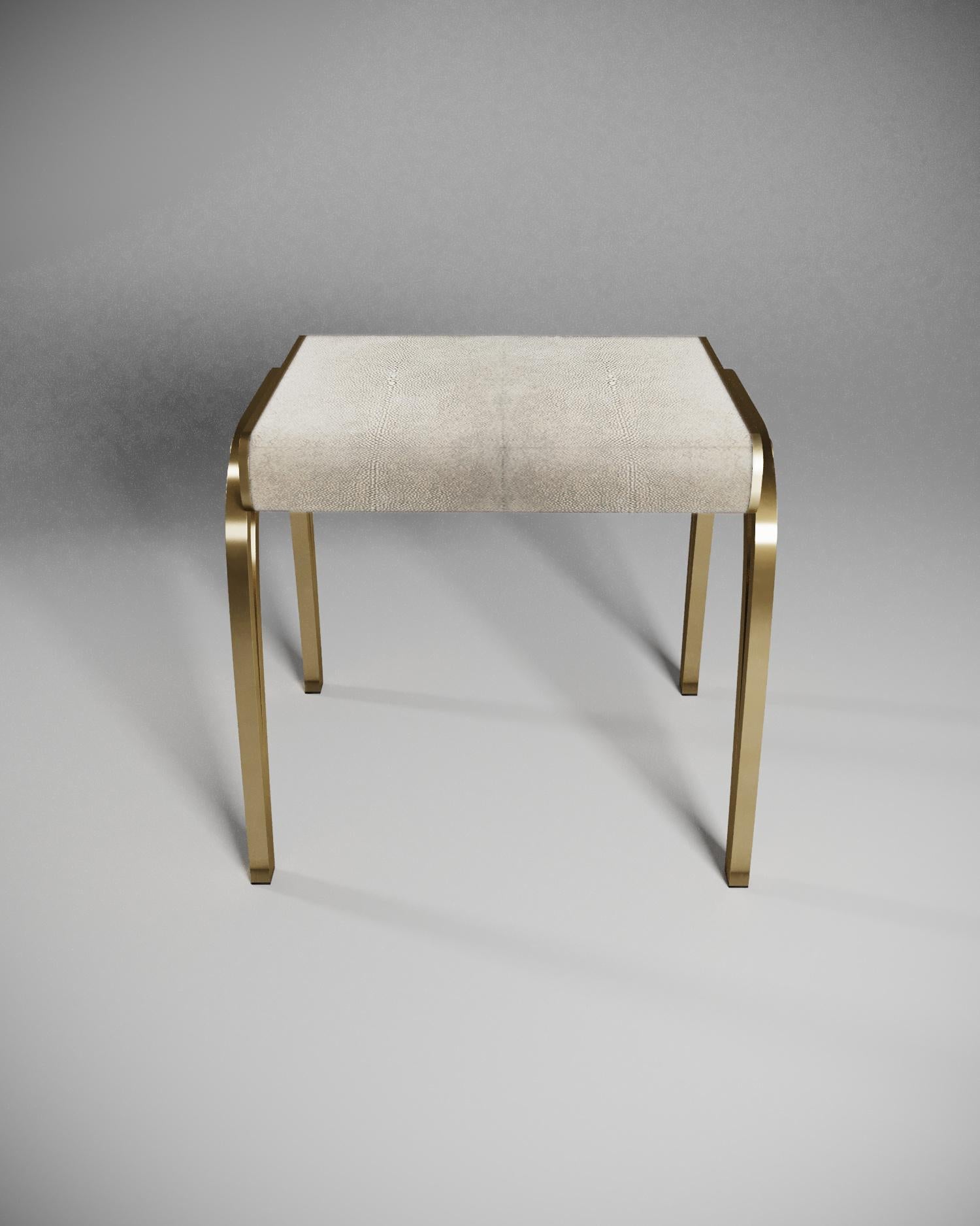 The limited edition Victoria stool by R & Y Augousti is a sophisticated piece that provides comfort, whilst retaining its elegant and luxurious aesthetic. The seat is inlaid cream shagreen, with a bronze-patina brass frame. Available in other finish