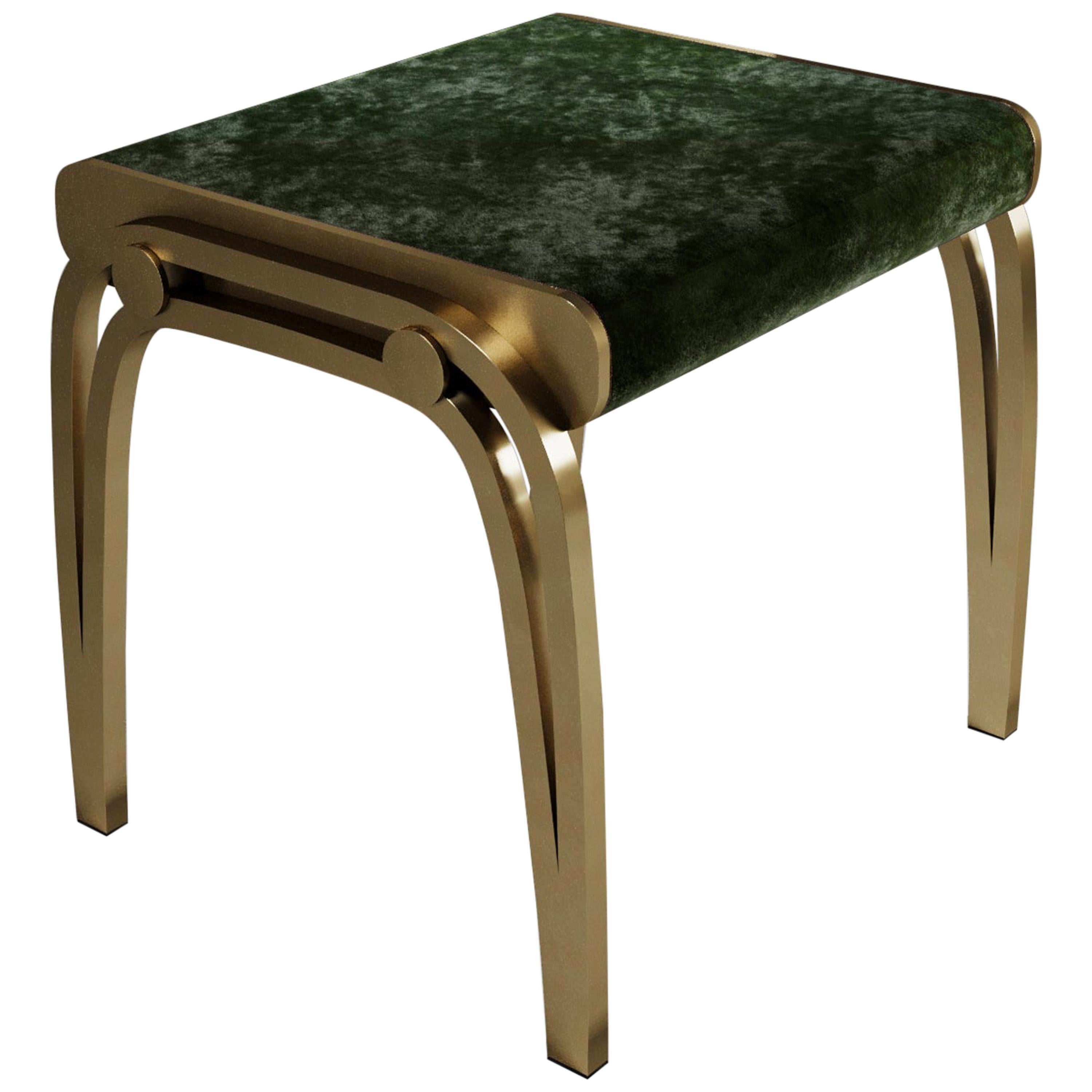 The limited edition Victoria stool by R&Y Augousti is a sophisticated piece that provides comfort, whilst retaining its elegant and luxurious aesthetic. The the seat is upholstered in a dark emerald green-hue Pierre Frey Velvet, with a bronze-patina