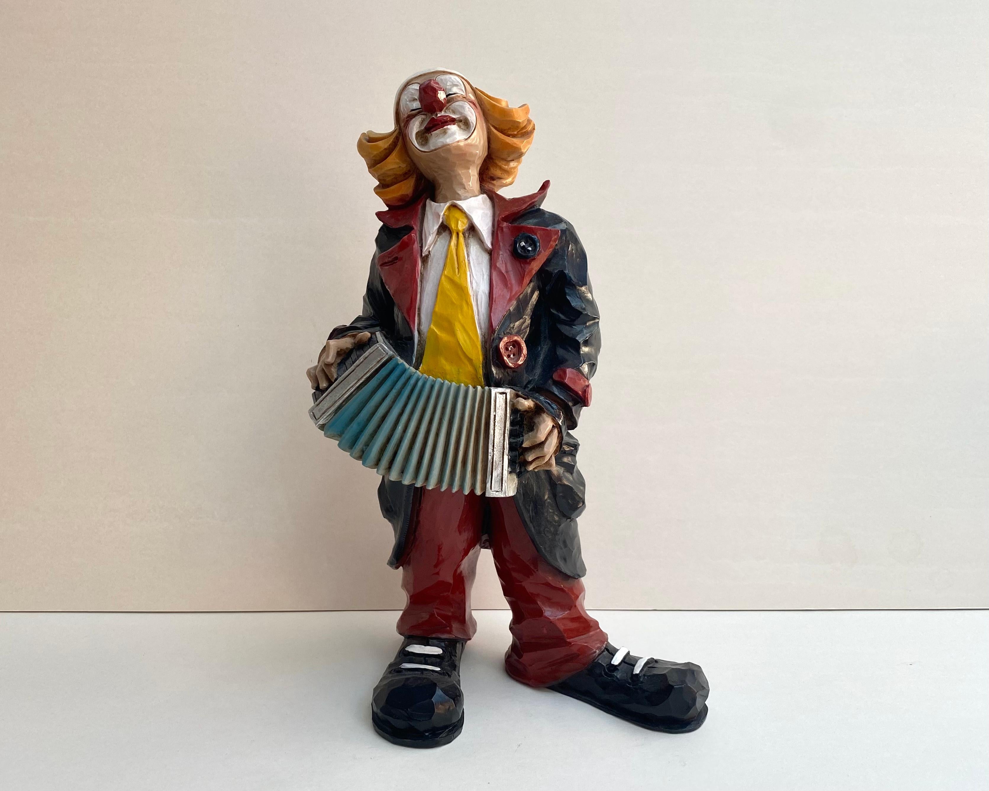 Vintage, rare figurine of a hand-painted porcelain clown with an accordion in his hands by Vivian C, Italy, 1980s.
 
Clothing, as befits a clown, flashy and colorful, with a tie that is too big.

Memories of fun hours at the circus are