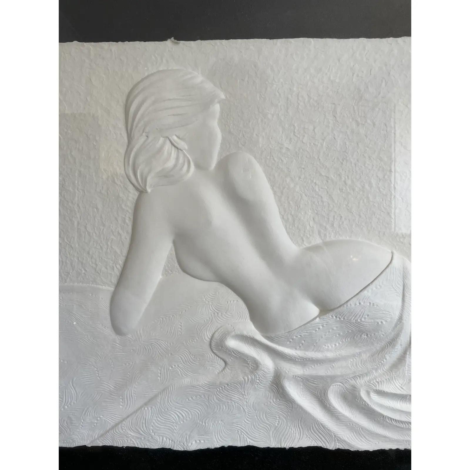 A paper mache base relief sculpture by portrait artist Roberta Peck, features a limited edition composition of a sultry reclining nude.
Signed and numbered 21/125 in pencil, showcased in a Chrome frame and contrasting black background.
Gallery