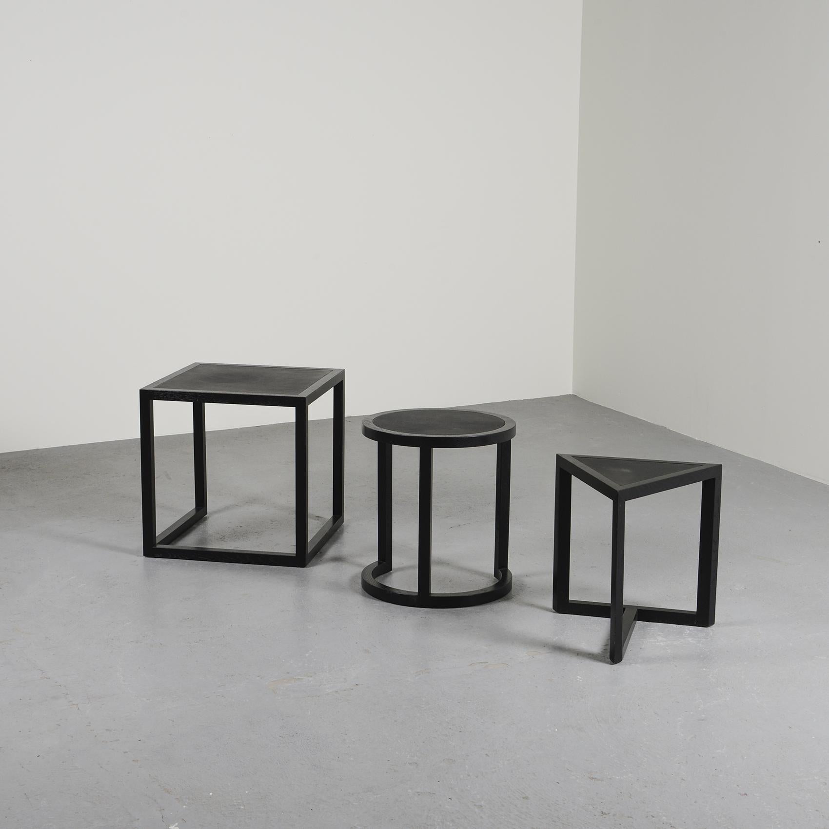 Nesting tables by Stefan Zwicky, model DS 9400, with a graphic design in square, round and triangular shapes.

The frame in black-stained solid oak is partially covered with leather on the tops.

Edition: De Sede, circa 1989.
Limited edition