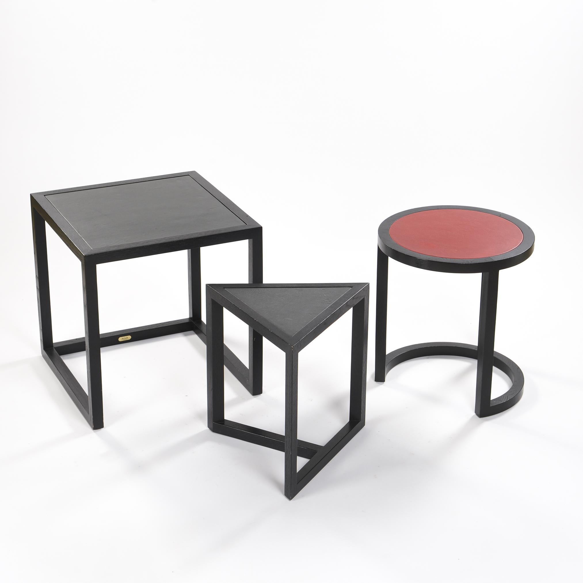 Nesting tables by Stefan Zwicky, model DS 9400, with a graphic design in square, round and triangular shapes.

The frame in black-stained solid oak is partially covered with leather on the tops.

Edition: De Sede, circa 1989.
Limited edition from