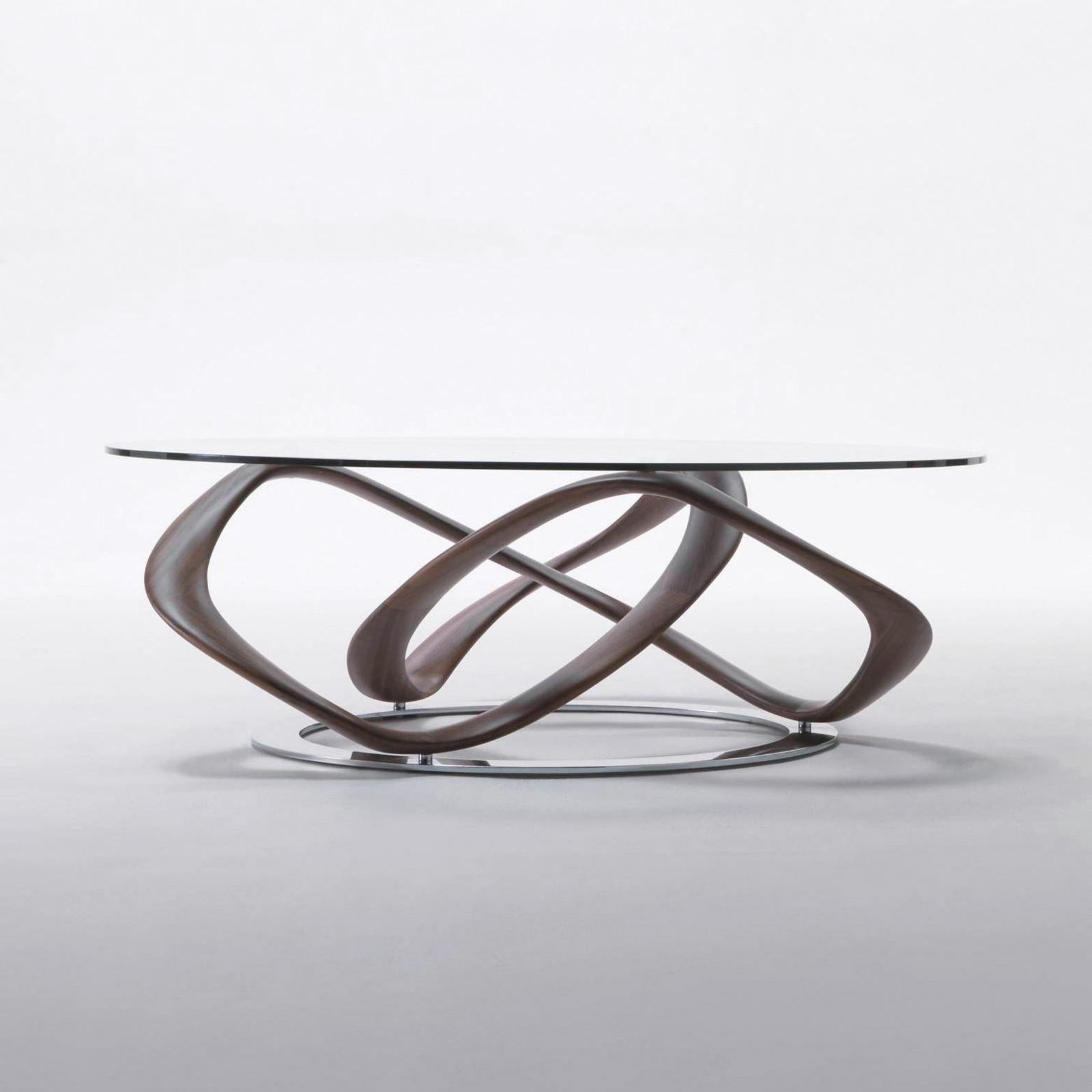 Coffee table Limitless with base in solid walnut wood,
handcrafted wood. On chrome-plated metal ground base.
With tempered clear glass top (10mm thickness).
Available on request in:
Diameter 120cm x height 39cm, price: 9600,00€.
Diameter 130cm x