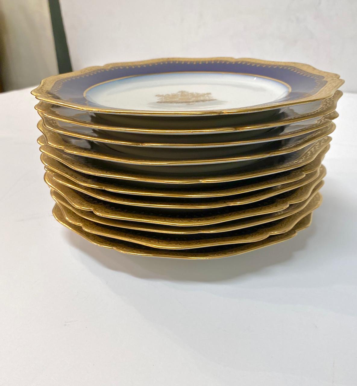 This is a superb set of 12 Limoges Cobalt rimmed dessert or salad plates. The scolloped rims of the plates are further enhanced by wide gold detailing. The centers of the plates are detailed by a fine gold lace medallion. The intensity of the cobalt