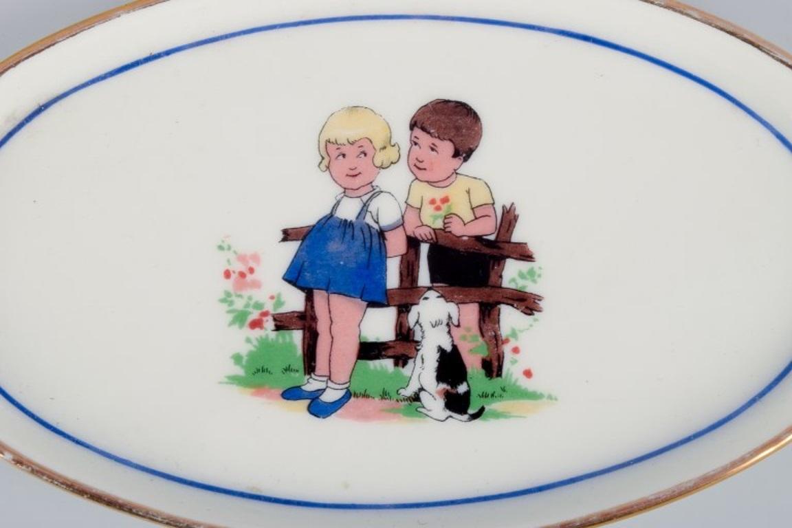 Mid-20th Century Limoges, Digoin & Sarreguemines, France. Children's porcelain dinnerware. For Sale