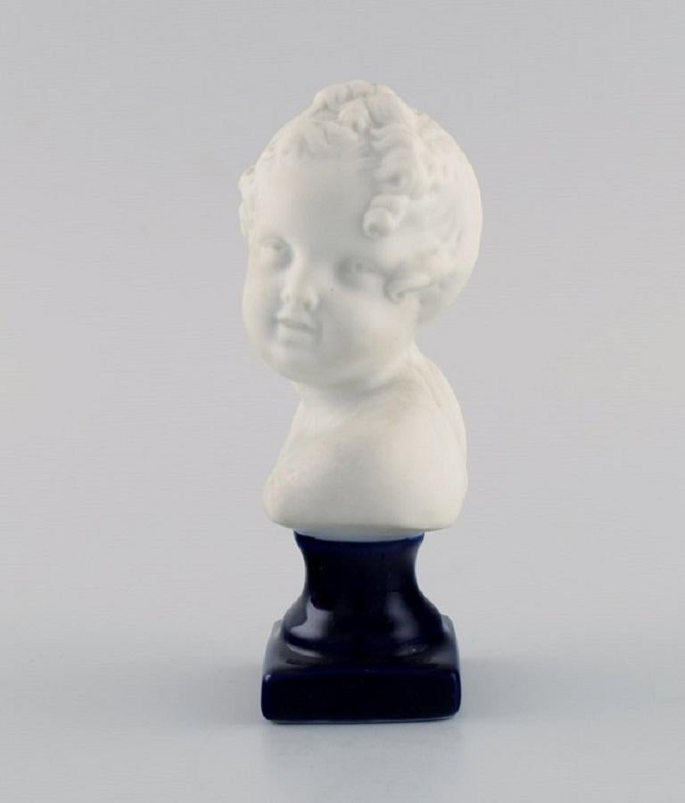 Limoges France. Biscuit child bust. Stand with dark blue glaze. 
Classic style. Early 20th century.
Measures: 13.5 x 7 cm.
In excellent condition.
Stamped.