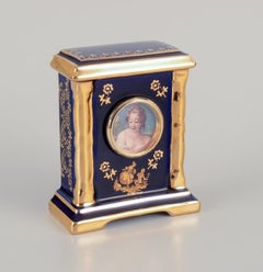 Limoges, France. Clock and decorative object in porcelain.