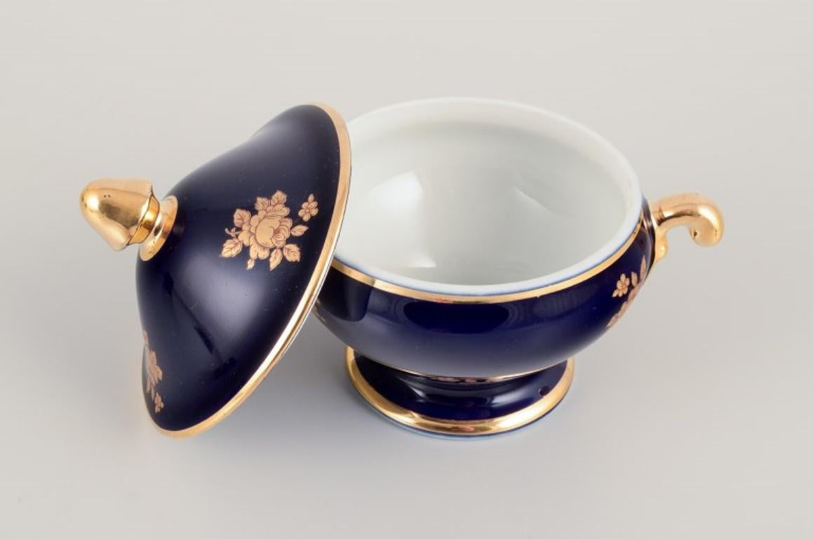 Limoges, France. Coffee cup, sugar bowl, and creamer in porcelain. In Excellent Condition For Sale In Copenhagen, DK