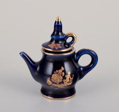 Limoges, France. Miniature porcelain set: cup, teapot, two pitchers and tray