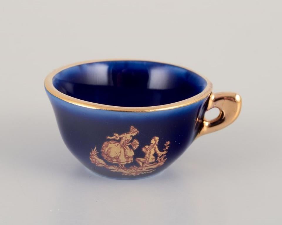 French Limoges, France. Miniature porcelain set: cup, teapot, two pitchers and tray