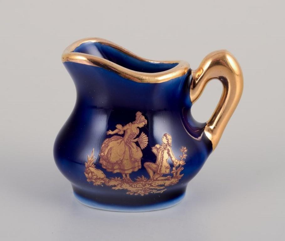 Glazed Limoges, France. Miniature porcelain set: cup, teapot, two pitchers and tray