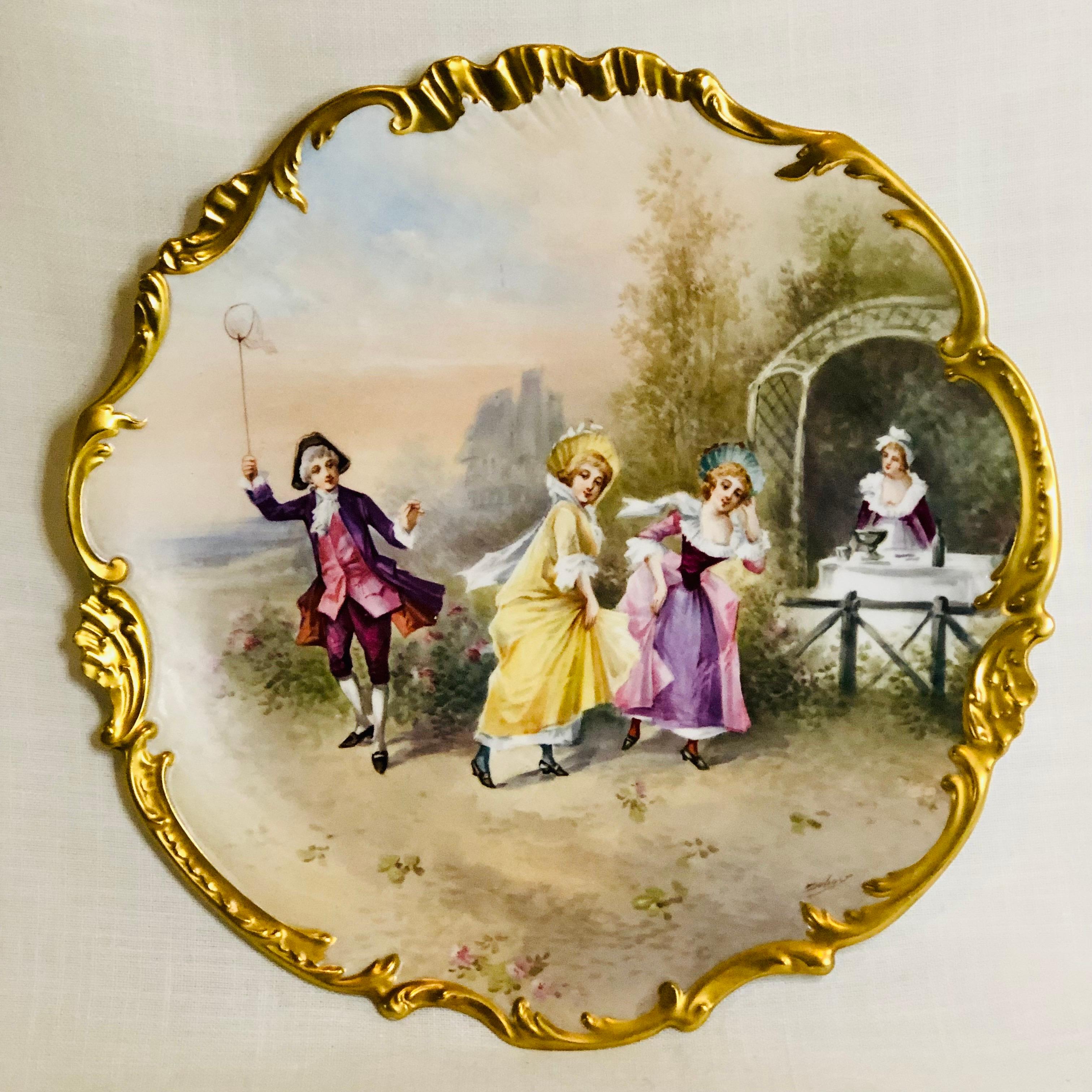 This is a wonderful Limoges porcelain plaque painted by the Limoges sought after artist Dubois. It is beautifully painted. It depicts a group of people dressed in late 19th century clothes enjoying a beautiful afternoon of outdoor festivities. The