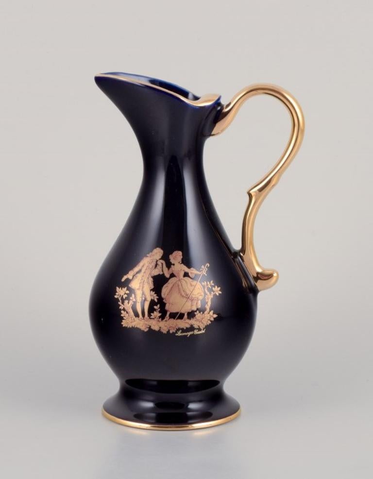 Limoges, France. Trois pichets et un vase en porcelaine décorée à la feuille d'or 22 carats. Magnifique glaçure bleu royal. Scène galante. 
Environ à partir de 1970.
Provenance : D'une grande collection privée française de porcelaine de