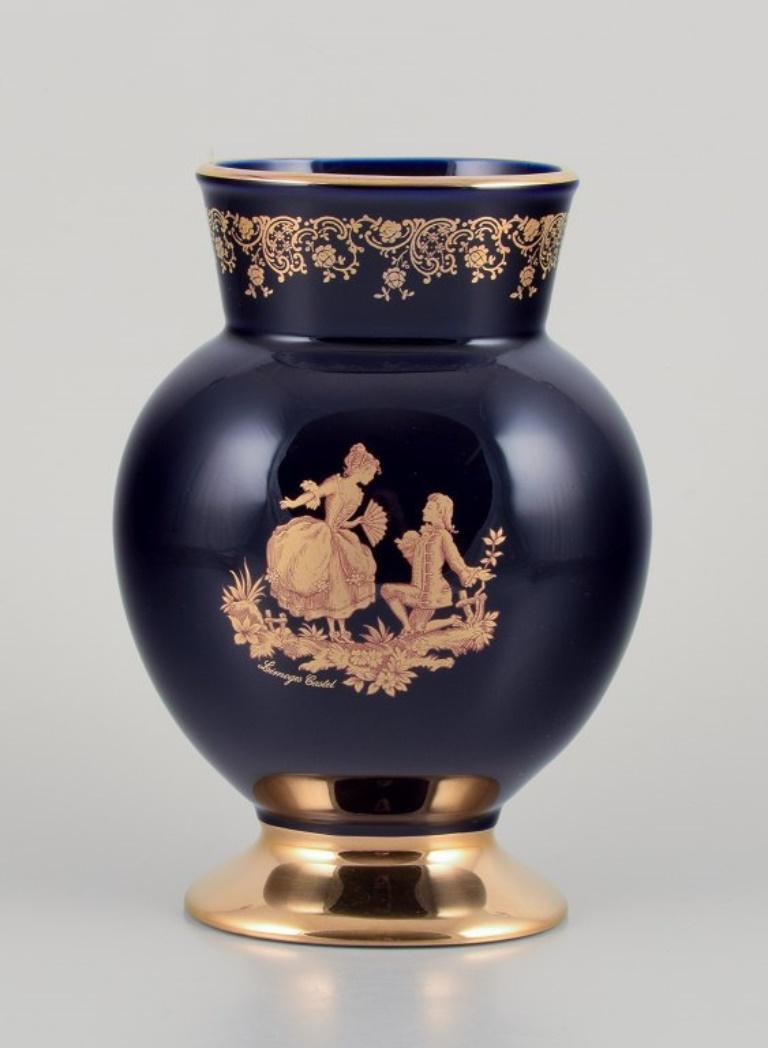 Limoges, France. Three porcelain vases decorated with 22-karat gold leaf and beautiful royal blue glaze. Scène galante. 
Approximately 1970.
Provenance: From a large French private collection of Limoges porcelain.
Marked.
In perfect