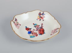 Limoges, France. Two deep children's plates in porcelain with gold rim.