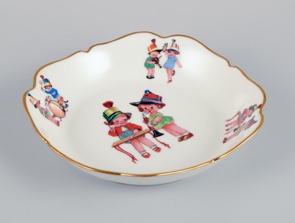 Mid-20th Century Limoges, France. Two deep children's plates in porcelain with gold rim.  For Sale