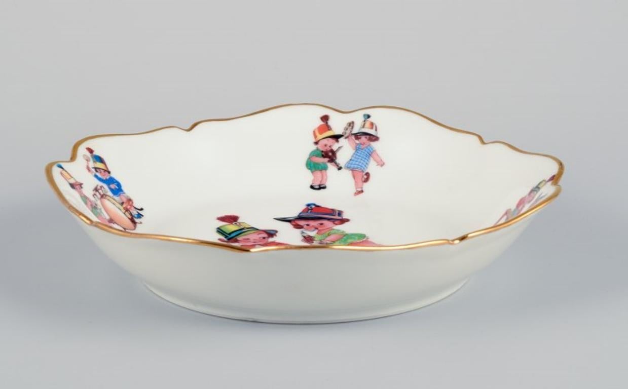 Porcelain Limoges, France. Two deep children's plates in porcelain with gold rim.  For Sale
