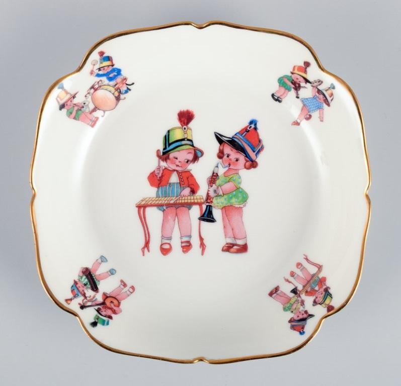 Limoges, France. Two deep children's plates in porcelain with gold rim.  For Sale 1