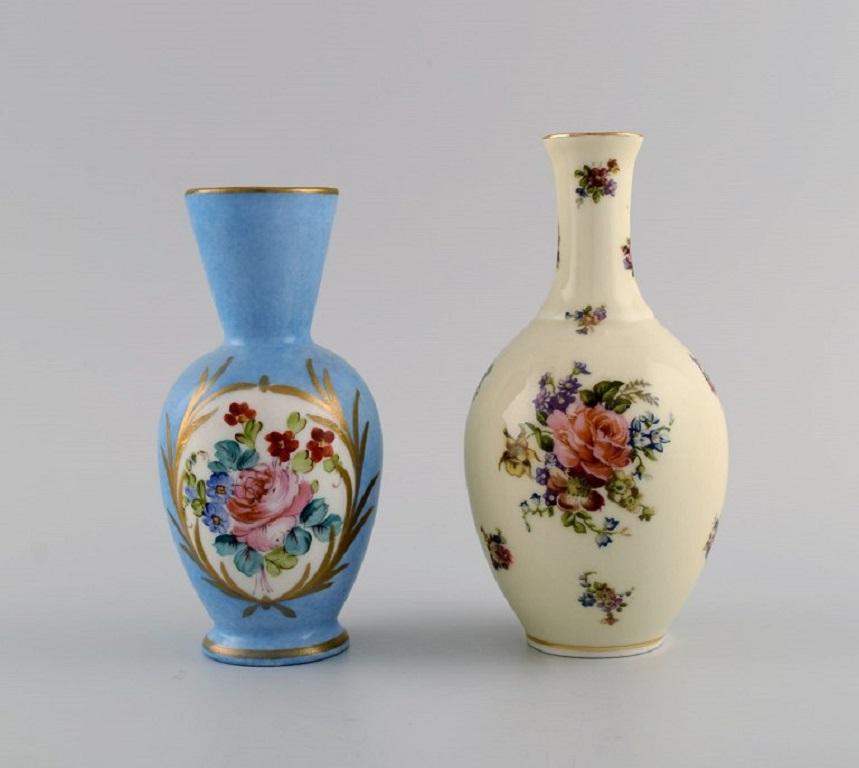 Limoges, Frankreich. Zwei Parfümflaschen, drei Vasen und eine Deckeldose aus handbemaltem Porzellan. 
Blumen und Goldschmuck. 1930er / 40er Jahre.
Die größte Vase misst: 15.5 x 8 cm.
Maße der Dose mit Deckel: 11.5 x 6 cm.
In ausgezeichnetem