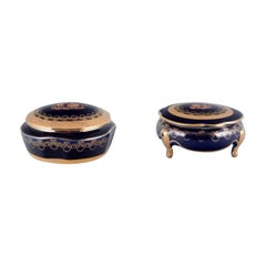 Limoges, France. Two porcelain boxes /  jars decorated with 22-karat gold leaf.