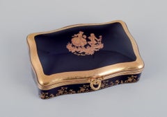 Limoges, France. Two porcelain boxes with lid decorated with 22-karat gold leaf