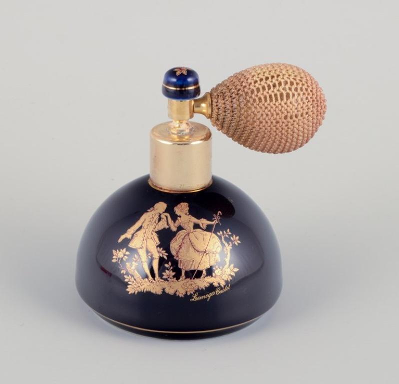 Limoges, France. Two porcelain perfume atomizers and a makeup mirror, decorated with 22-karat gold leaf and a beautiful royal blue glaze. Scène galante. 
Approximately 1970.
Provenance: From a large French private collection of Limoges