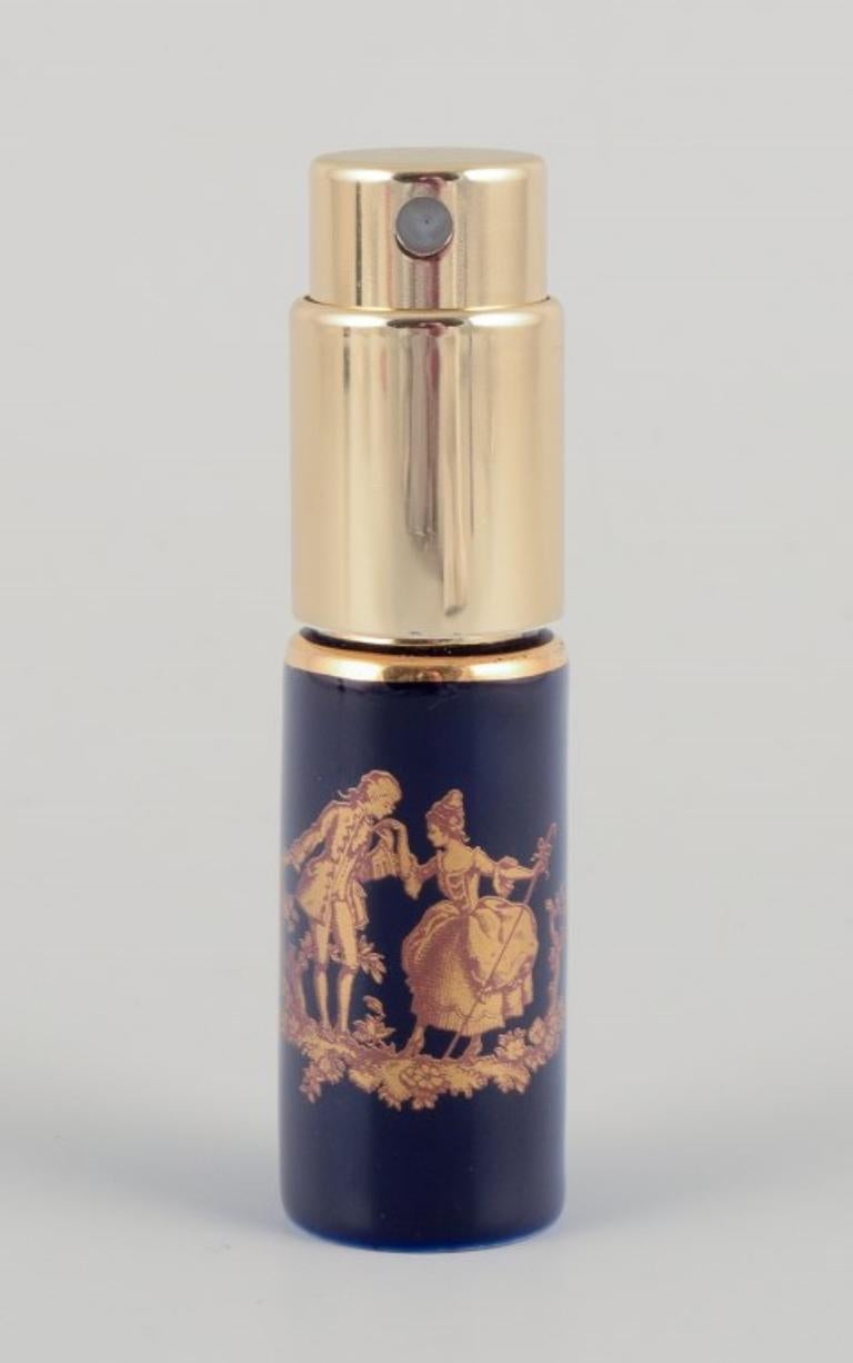 Glazed Limoges, France. Two porcelain perfume atomizers and a makeup mirror