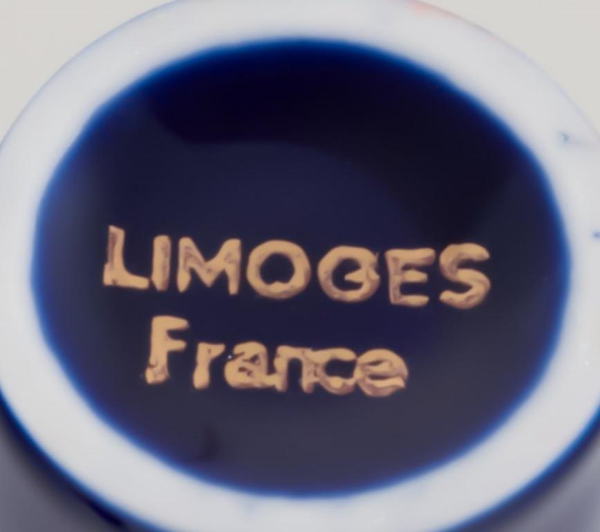 Limoges, France. Two porcelain perfume atomizers and a makeup mirror 2