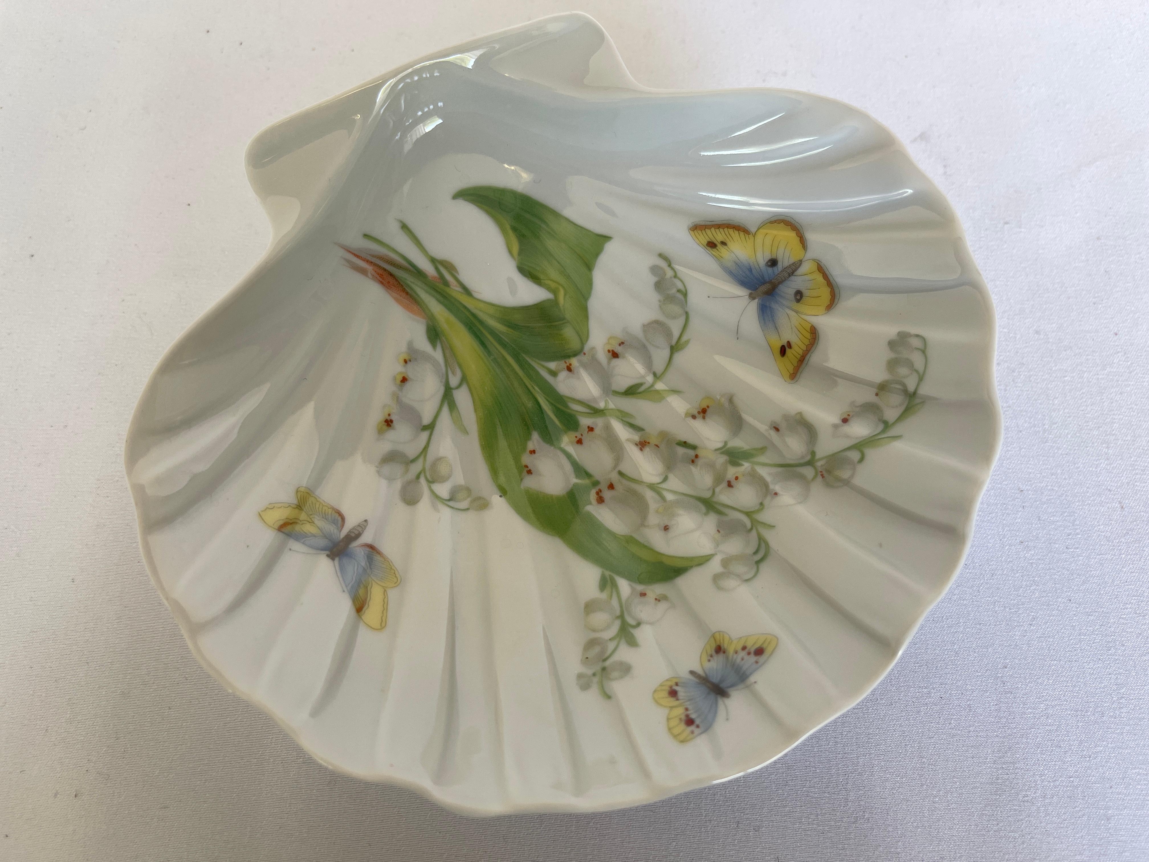 Limoges white porcelain sea shell dish with hand painted lily-of-the-valley and butterfly design, c. mid 20th century, France.
Signed Limoges France on bottom.
 