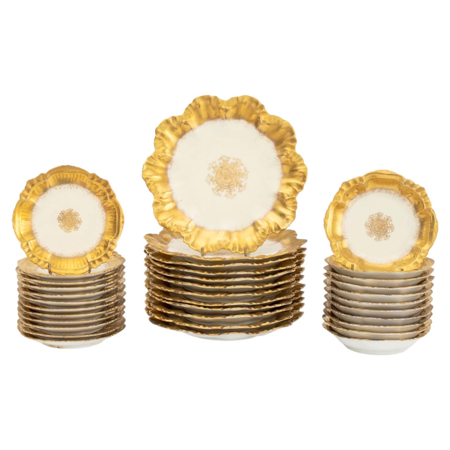 Collection of 35 Pieces of Limoges Gilt Decorated Porcelain Tableware For Sale