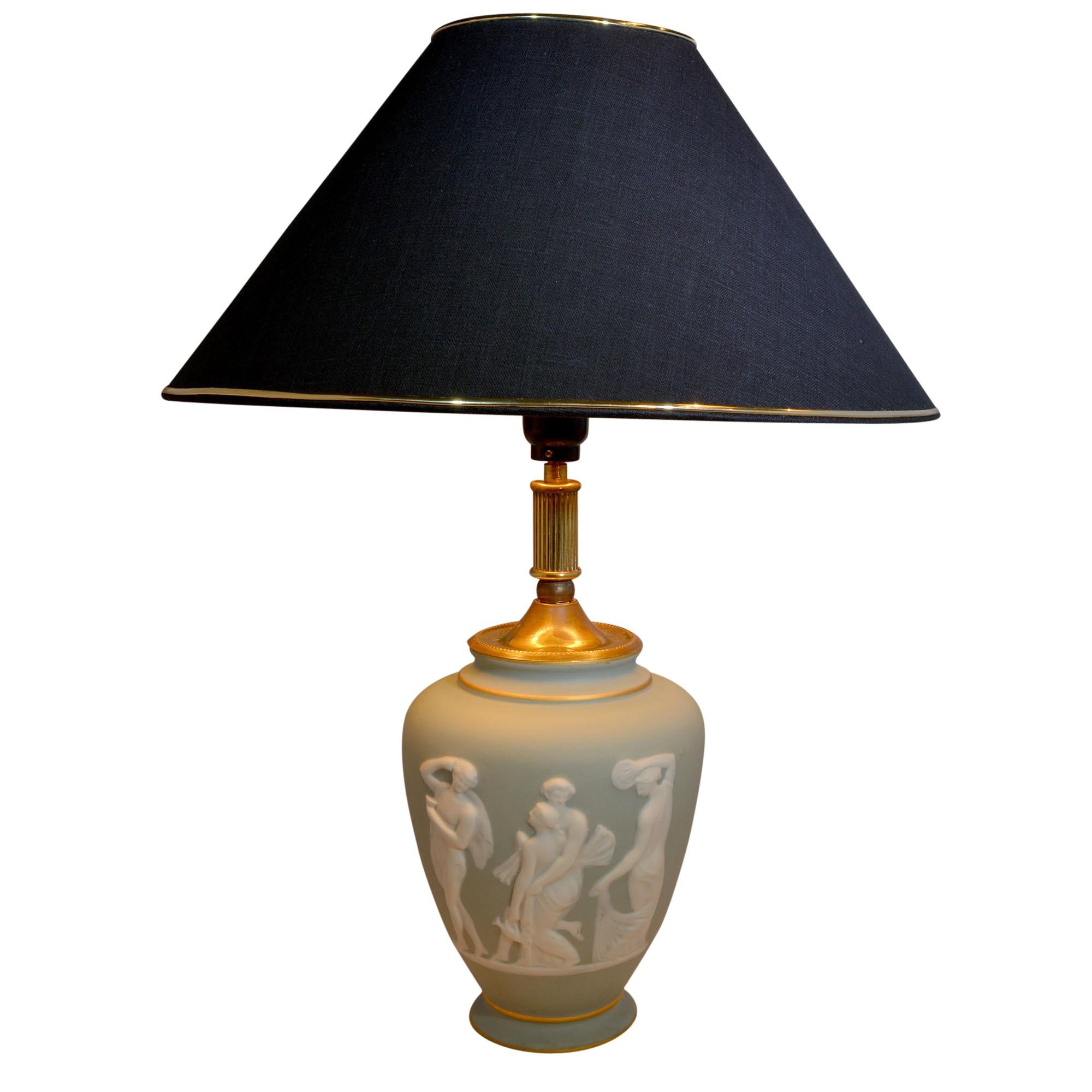 Beautiful soft green base features Pâte-sur-pâte (paste on paste) relief design of Grecian goddesses. The urn shaped body has hand painted French line accents at the bottom and top. The lamp comes with a custom, handmade shade. The shade is black
