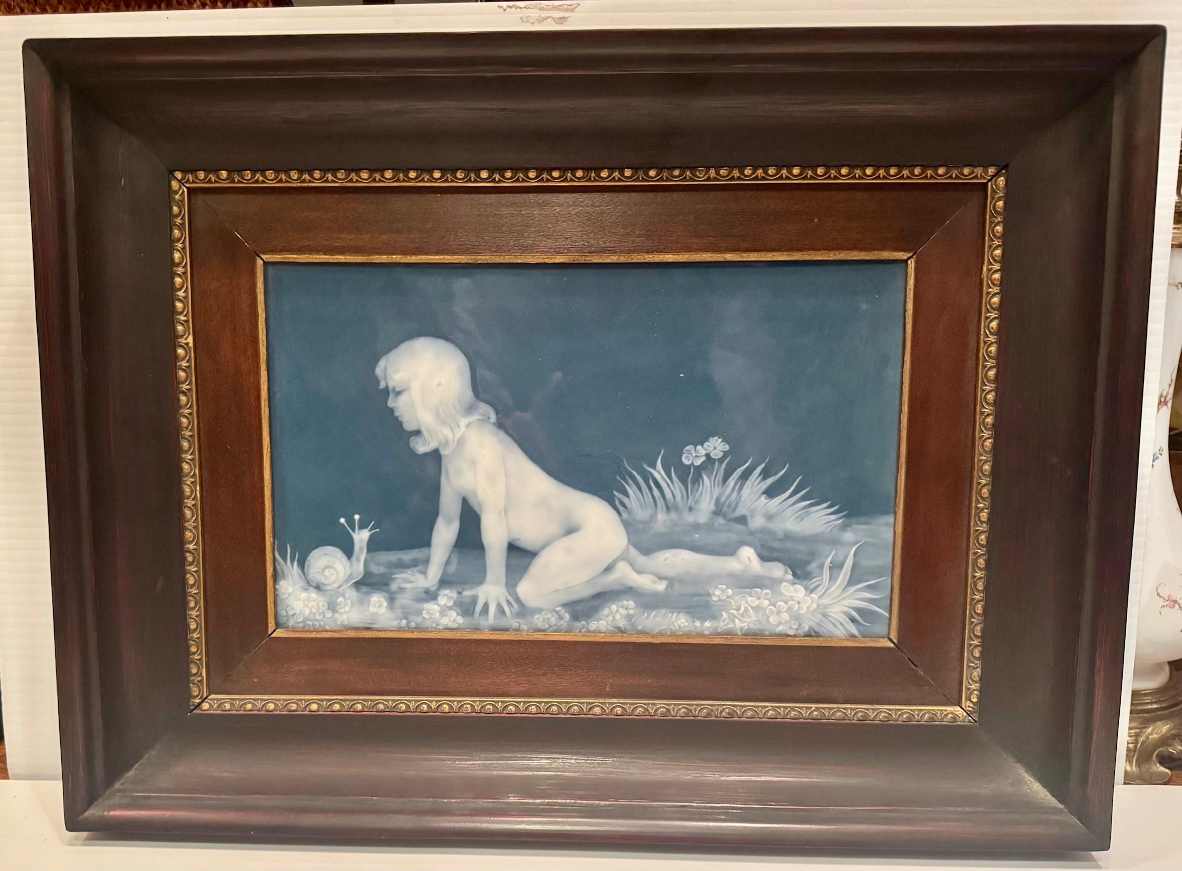 A Limoges pate sur pate porcelain plaque, depicting a young girl examining a snail which in turn is looking back curiously. Both the child and the snail are very skillfully modeled as is the lawn and flora this charming plaque is hard paste and very