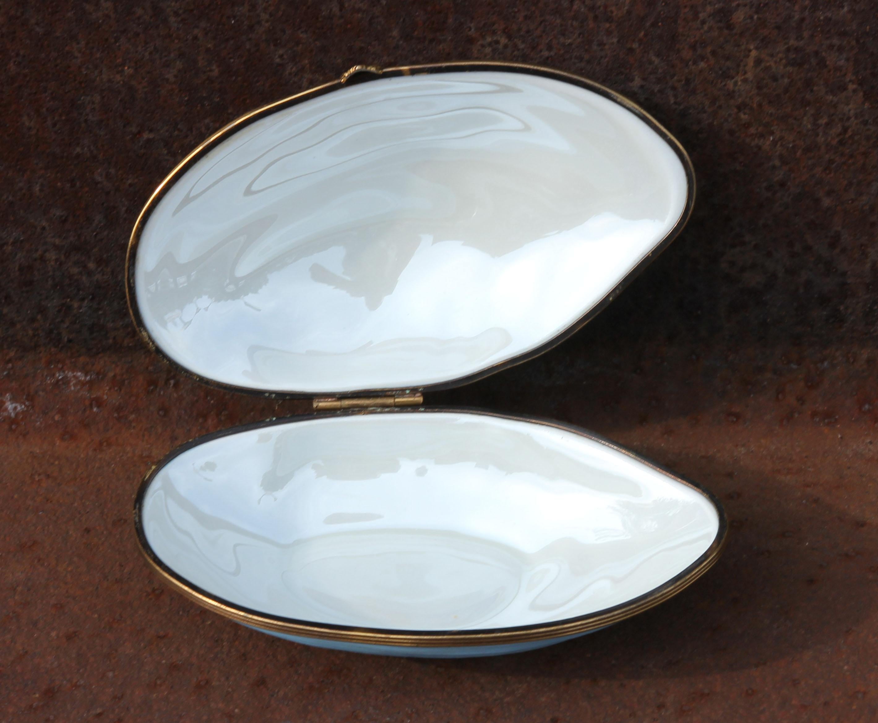 Limoges clamshell trinket box with bronze mounts.