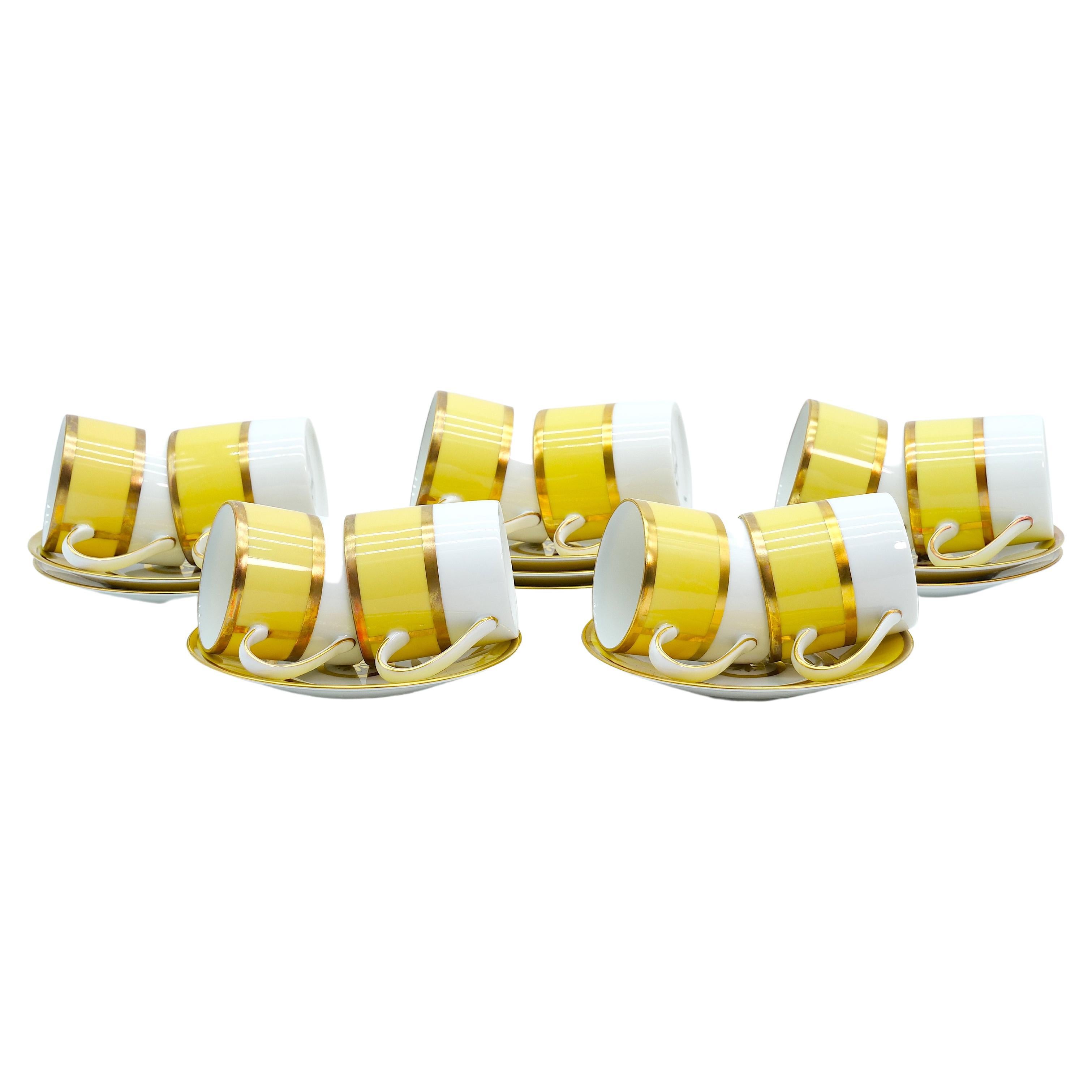 Beautiful French Porcelain dinner service for ten people made by limoges for  Bernardaud.  The tableware is decorated with a wide yellow edges and gilt gold colored rim in a white back-ground. The porcelain service is of a great quality & in great