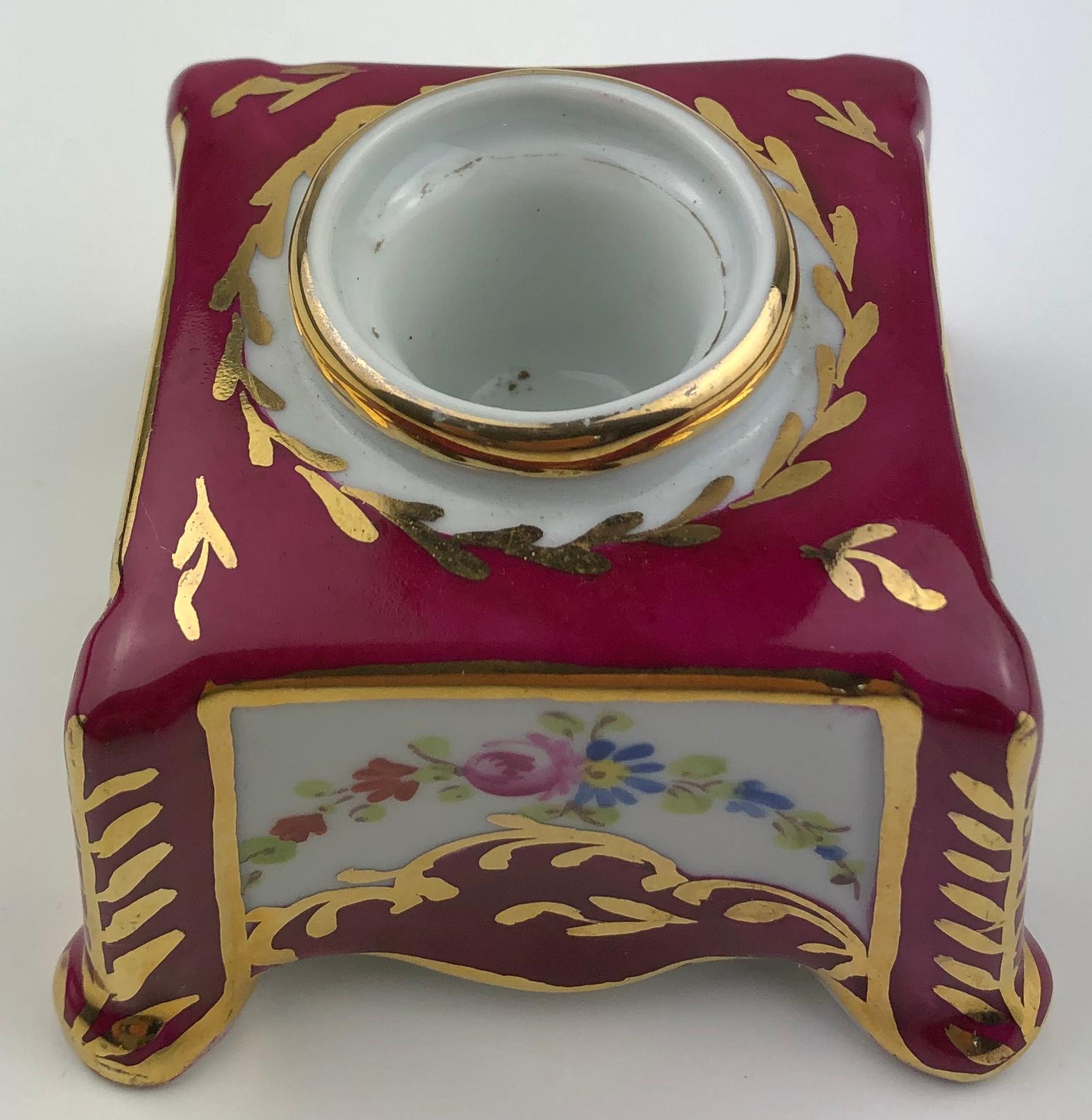 Beautiful hand painted porcelain candleholder by Limoges.
The prominent white and burgundy tones are very pleasing to the eye as are the exquisite details including gold trims with accentuating floral designs. 

Very good condition, no cracks or