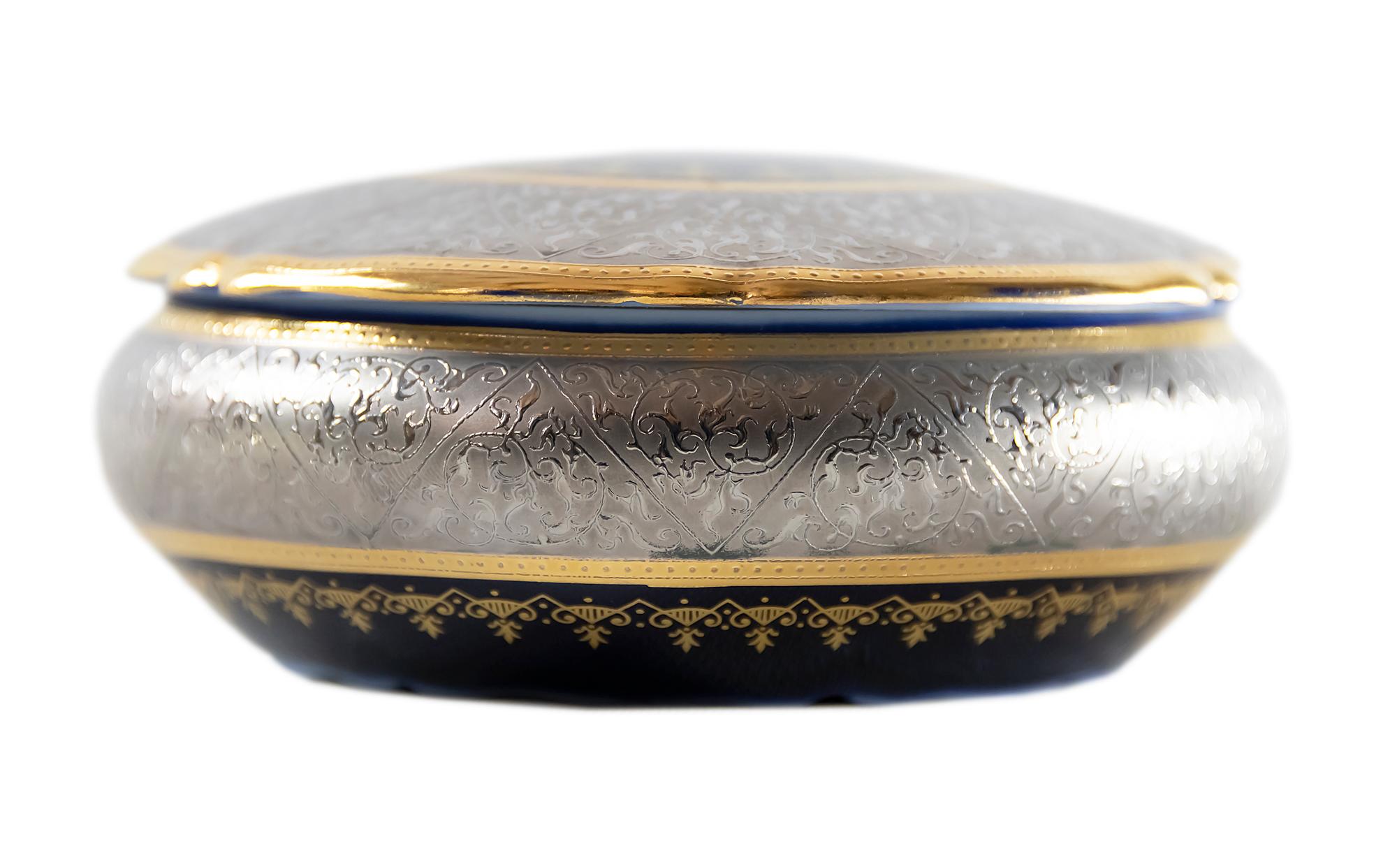 Cobalt blue porcelain jewelry box decorated with silver and gold decor produced by Limoges France.