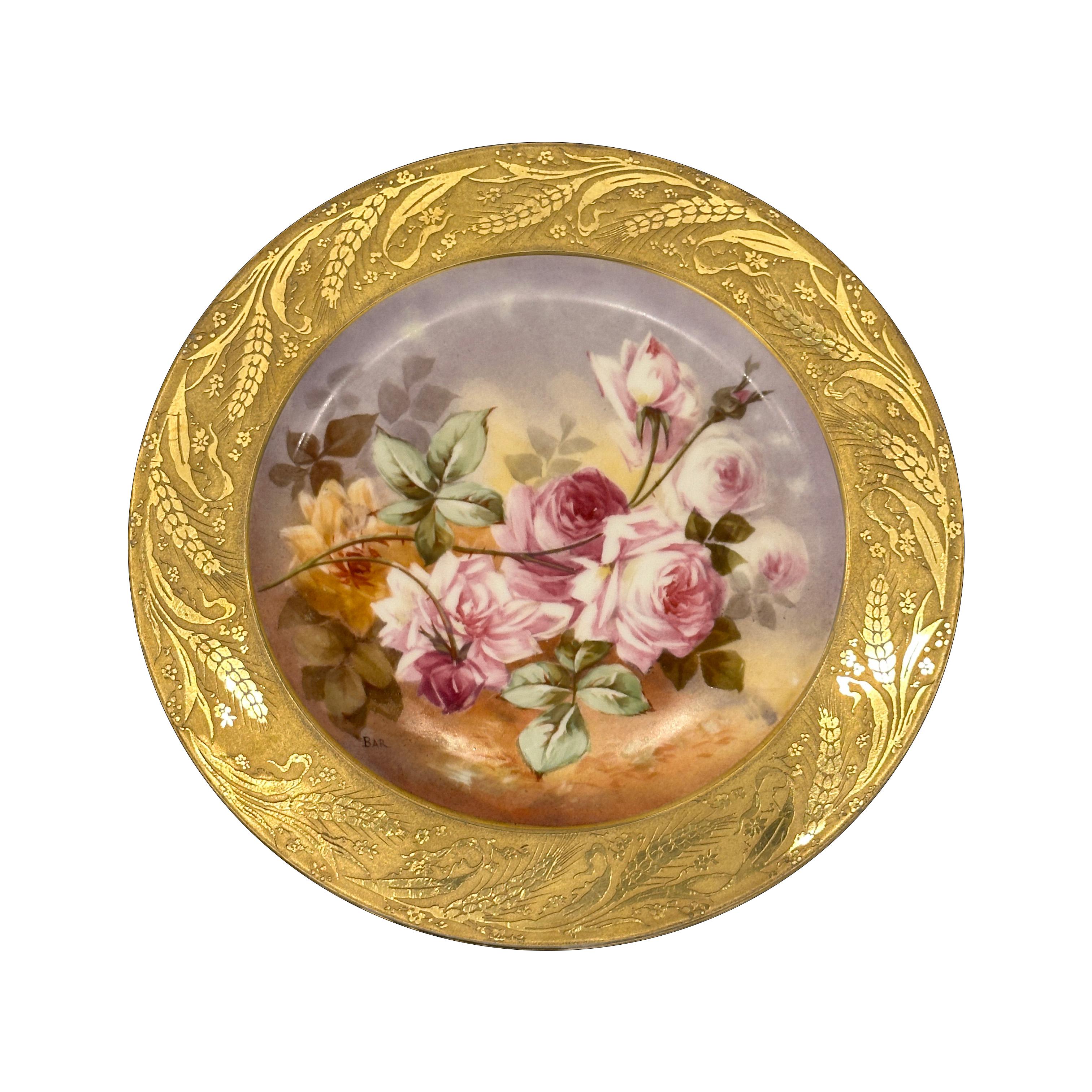 An elegant Limoges porcelain plate, beautifully executed by the esteemed Paroutaud Frères (B & P), operating in Limoges, France, during the early 20th century. This plate exemplifies the refinement and delicacy of French floral porcelain