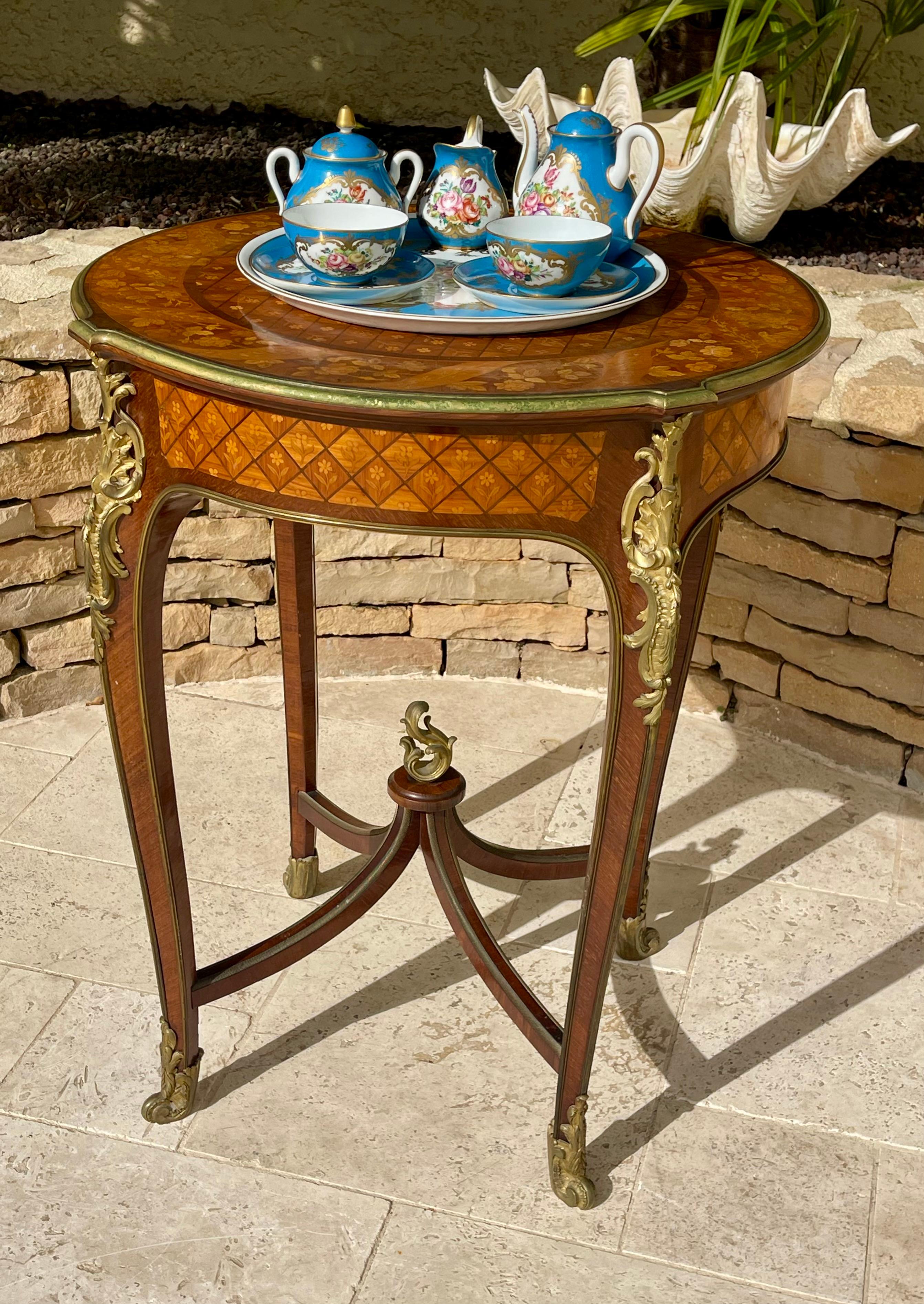 Limoges porcelain tea or coffee service in the Sèvres style. This service consists of two cups and saucers, a sugar bowl, a milk jug, a teapot, and a tray. The set is decorated with flowers on a blue background. All pieces are in very good condition.