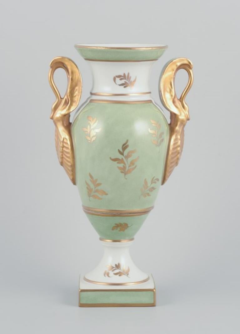 Hand-Painted Limoges/Sevres, France. Porcelain vase on a pedestal, handles shaped like swans.