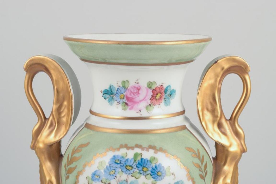 Limoges/Sevres, France. Porcelain vase on a pedestal, handles shaped like swans. 1