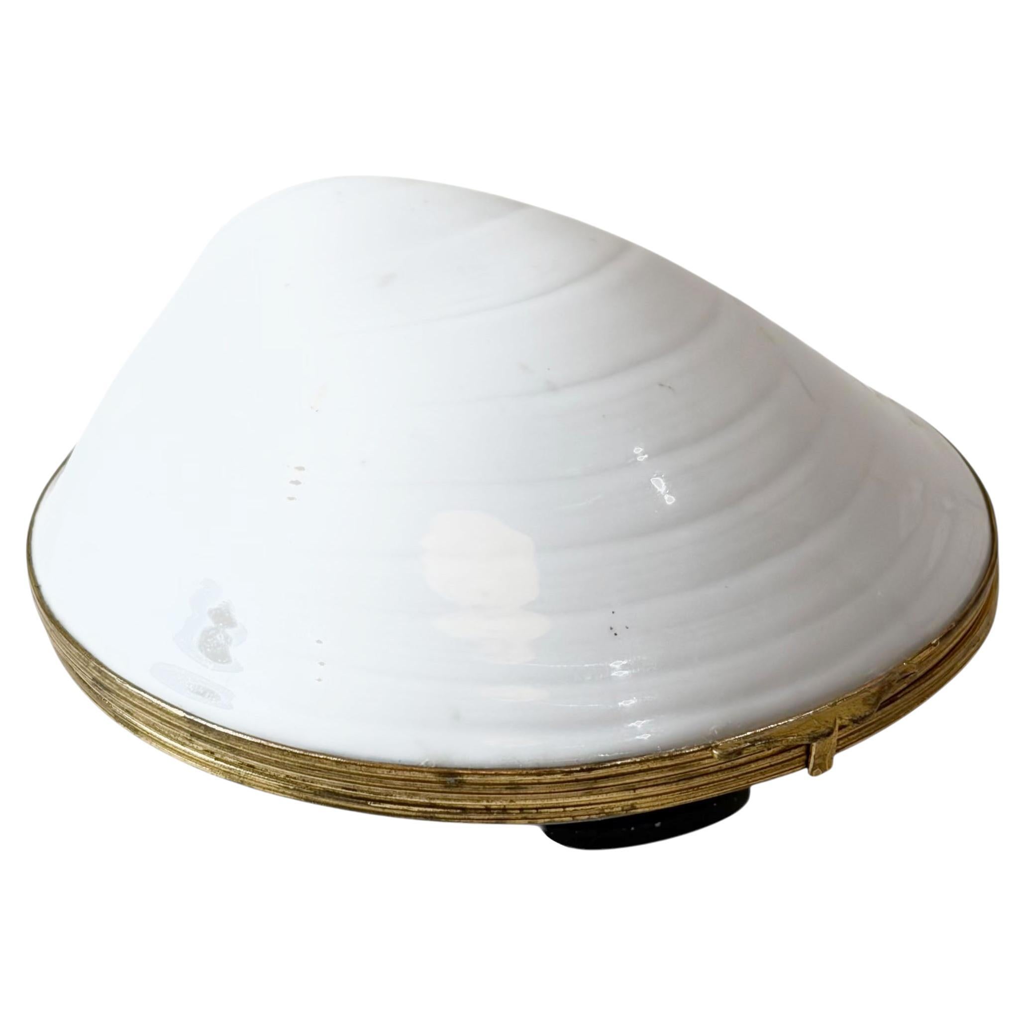 Limoges porcelain shell box, made in France in the early 1970s. Formed as a naturalistic shell, it is finished with a finely cast dore bronze mounting that frames the porcelain and highlights its sculptural shape. The box is signed and opens to a